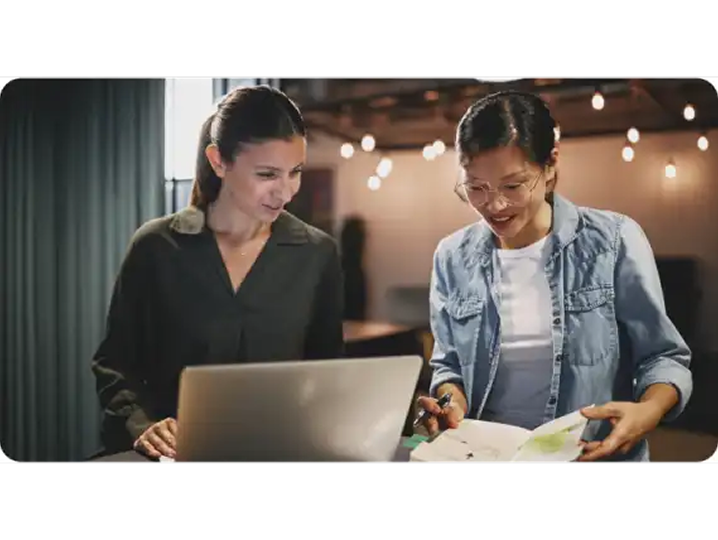 Two business owners reviewing their brand documents together