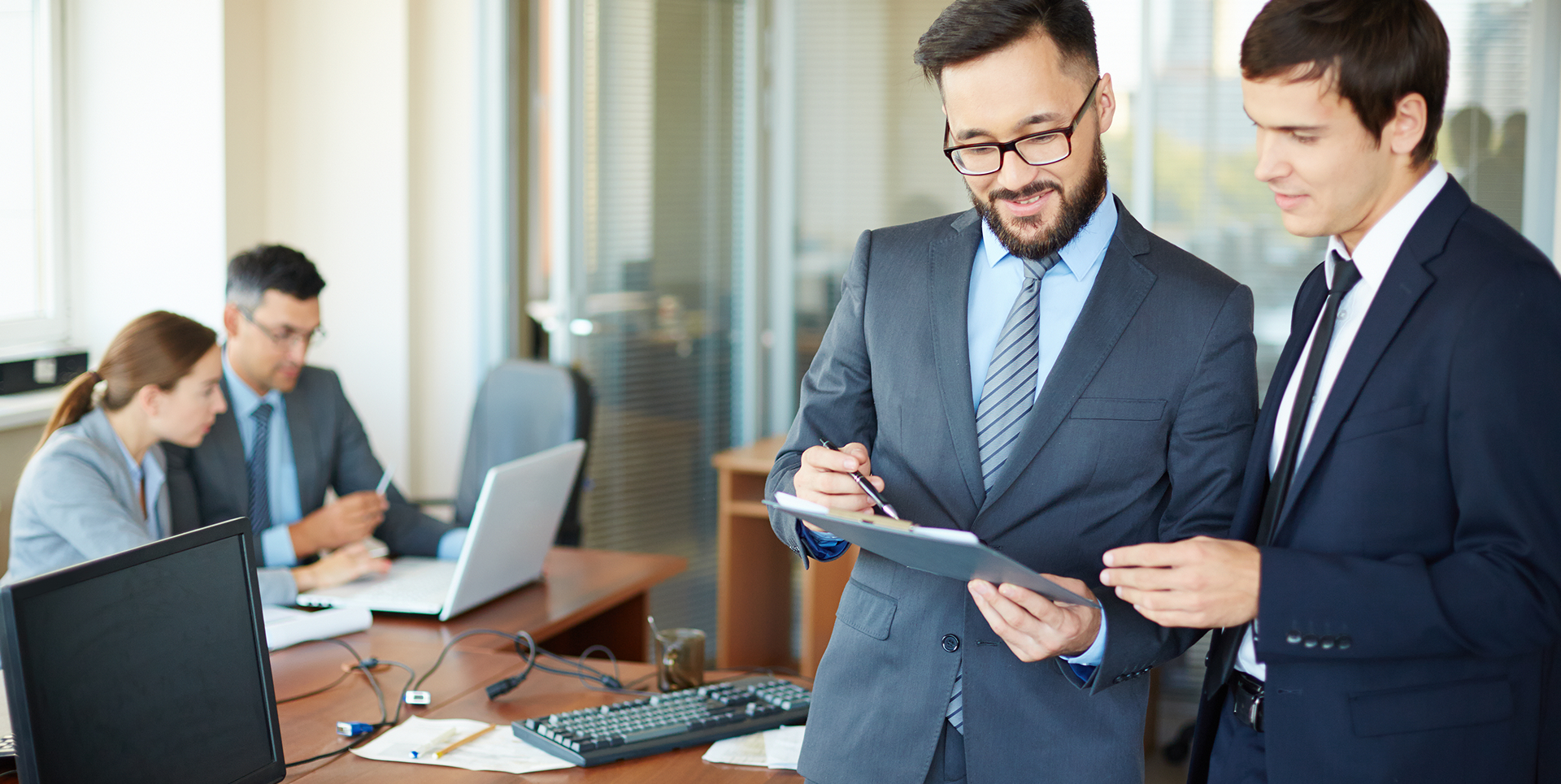 Business professionals reviewing a trademark office action